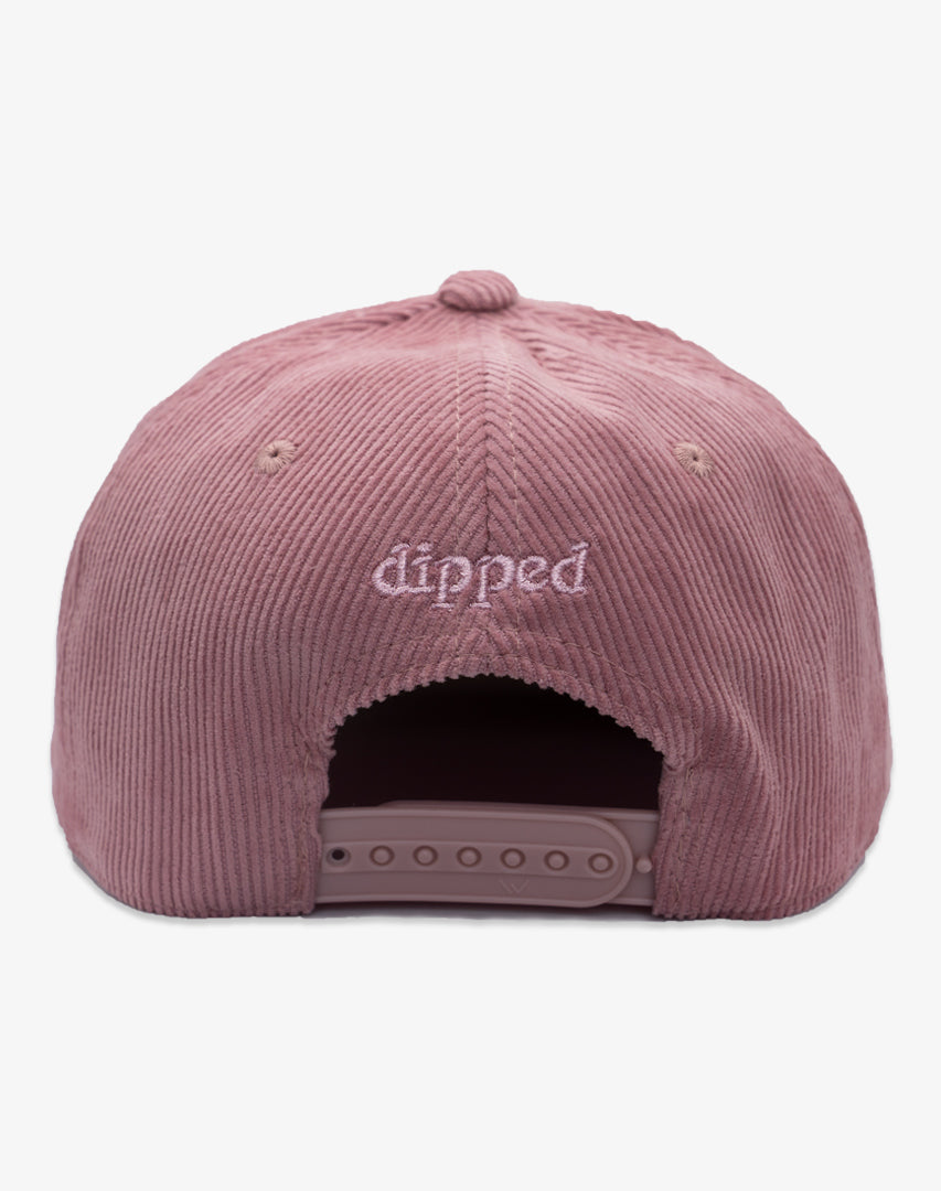 Pink corduroy cap with 'dipped' logo on a white background
