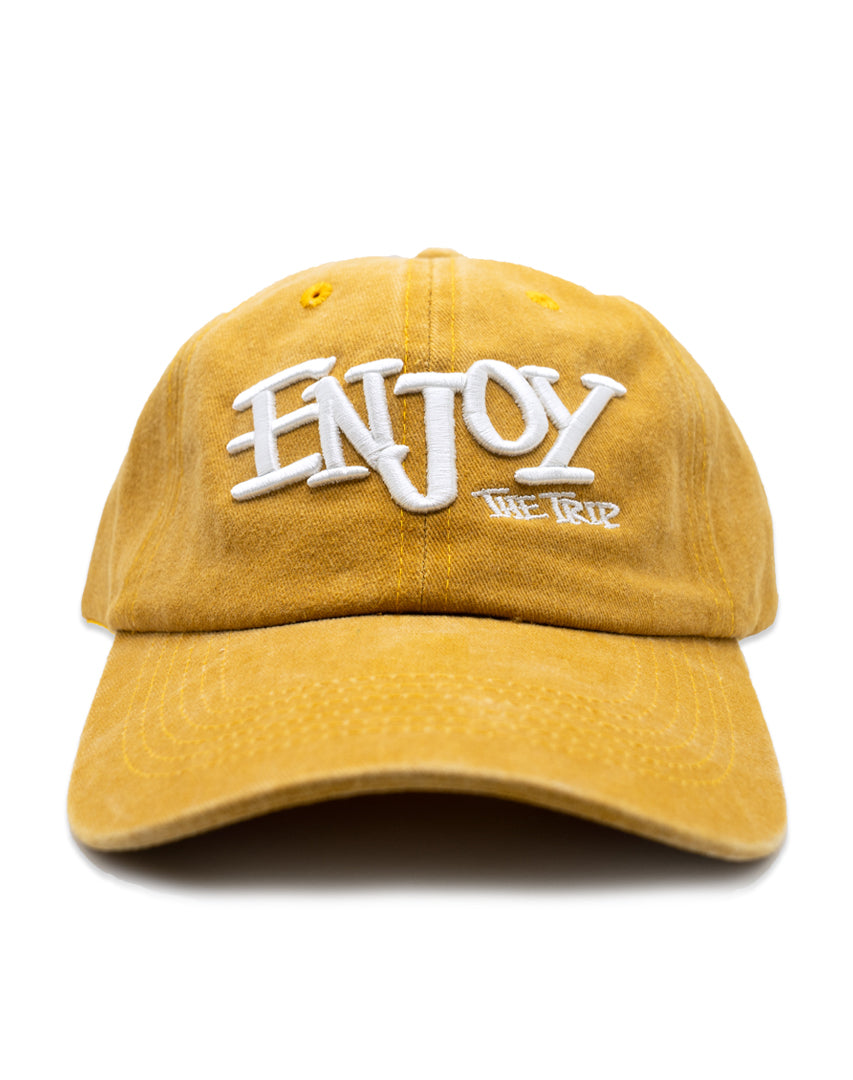 Mustard Washed Cotton Dad Hat with white embroidery 'ENJOY THE TRIP' on a white background