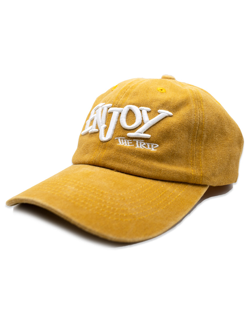 Mustard Washed Cotton Dad Hat with white embroidery 'ENJOY THE TRIP' on a white background