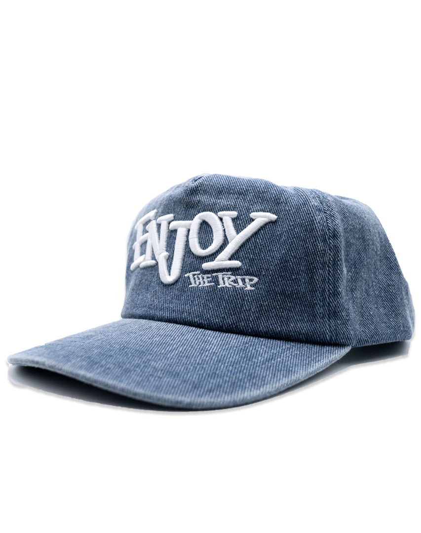Blue Washed Denim hat with white embroidery 'ENJOY THE TRIP' on a white background